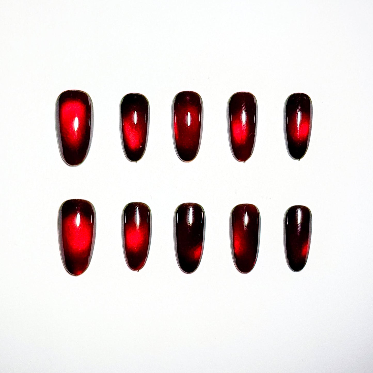 Red nail polish samples on a white background