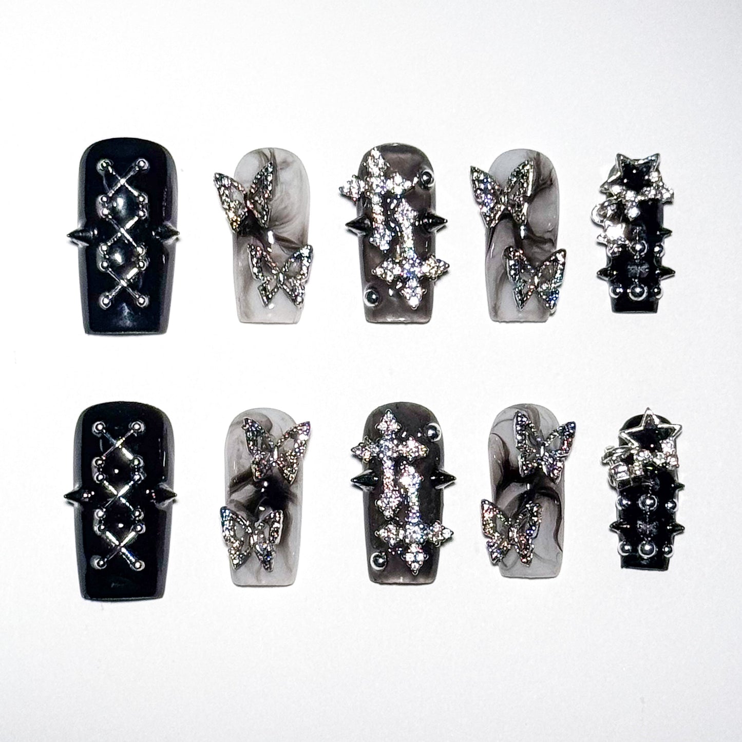 Set of black and silver nail art designs on a white background