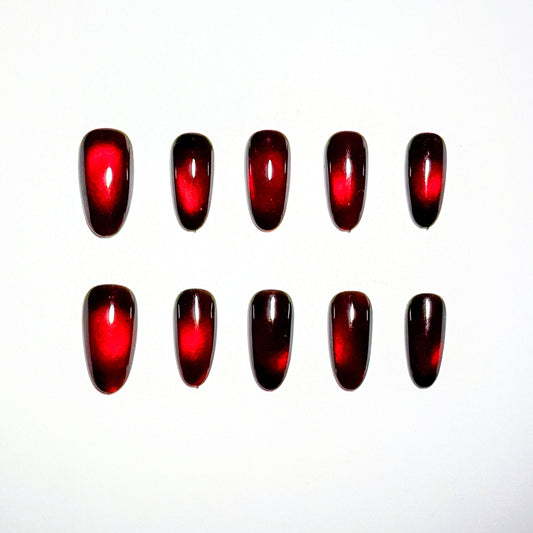 Red nail polish samples on a white background