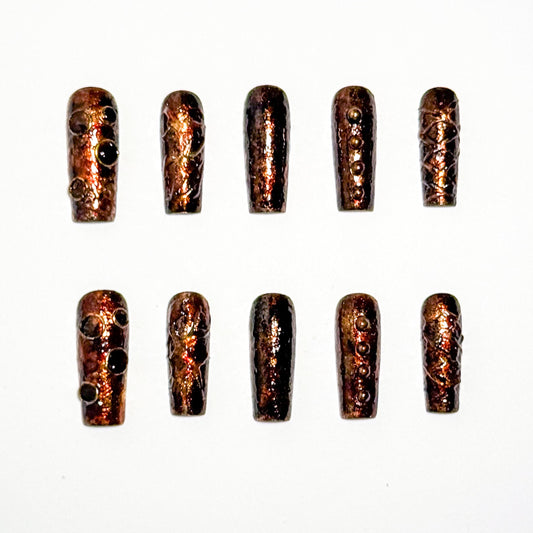 Set of metallic nail tips on a white background